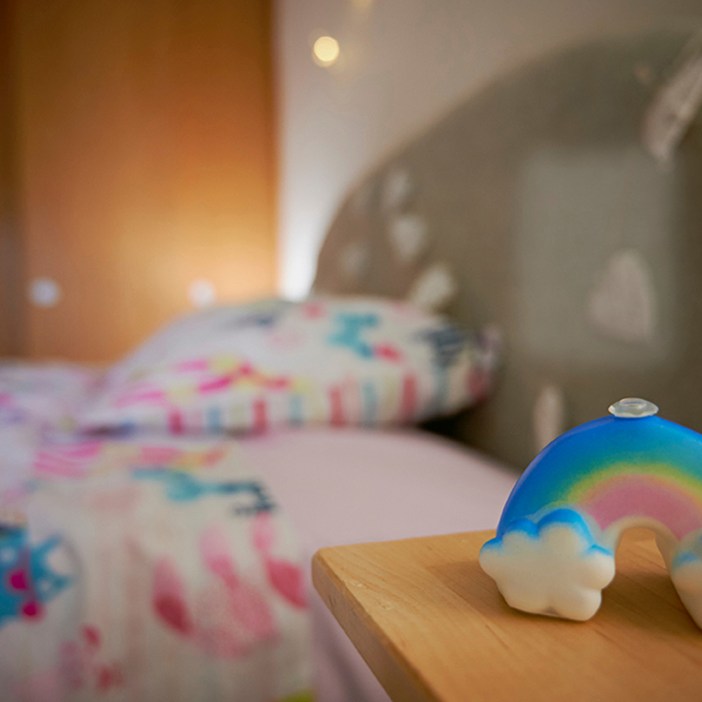 A bedroom interior focussing on a rainbow light