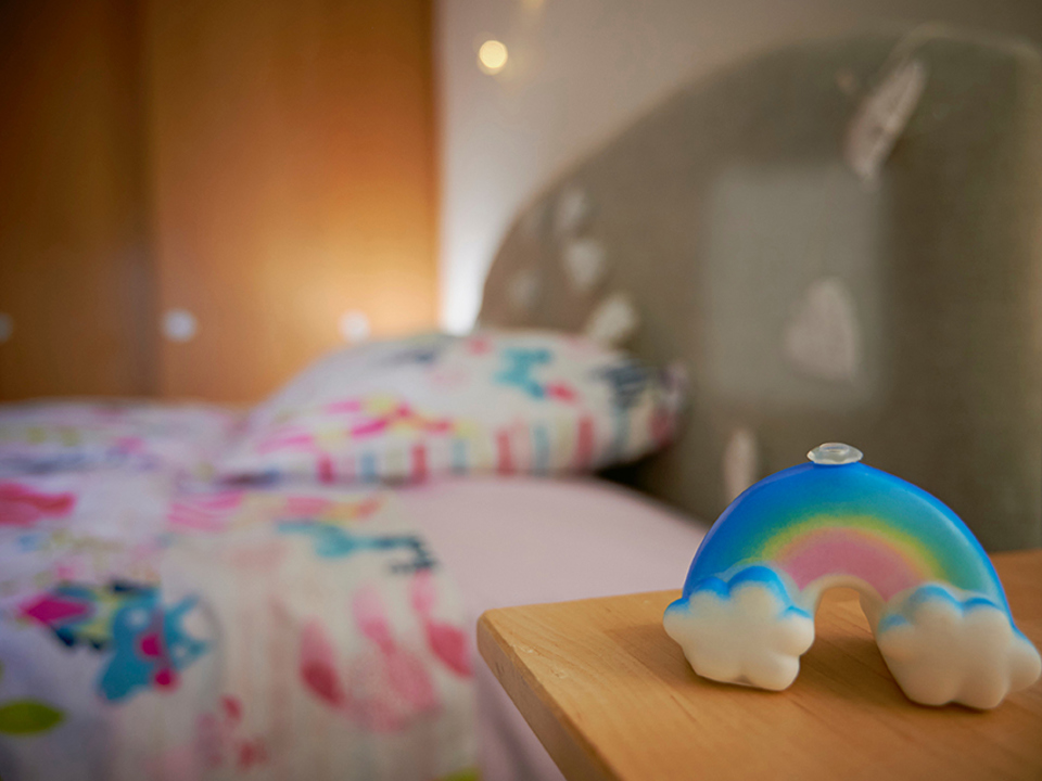 A bedroom interior focussing on a rainbow light