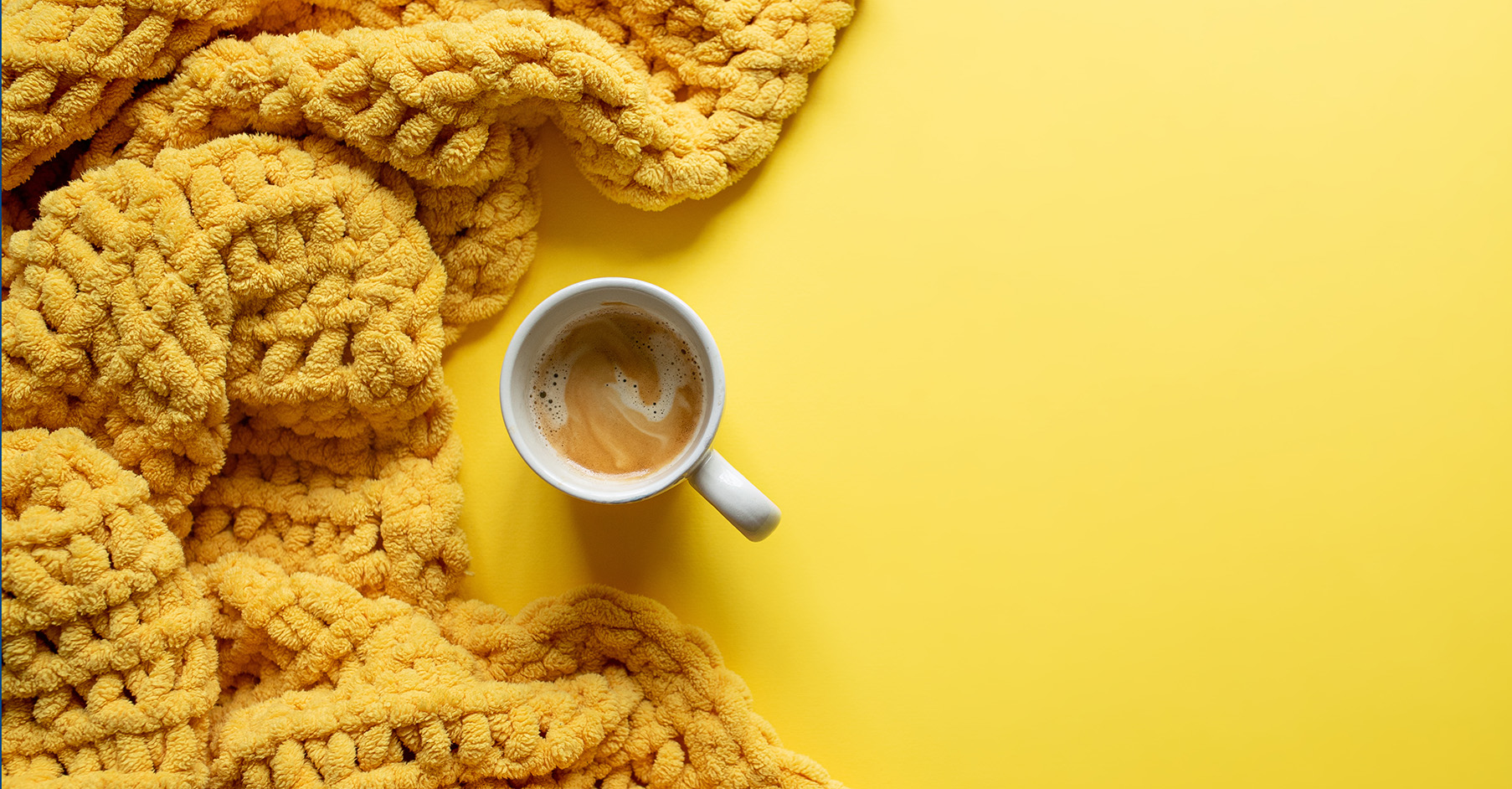 Knit Challenge header showing a yellow knitted blanket next to a cup of tea or coffee on a yellow background.
